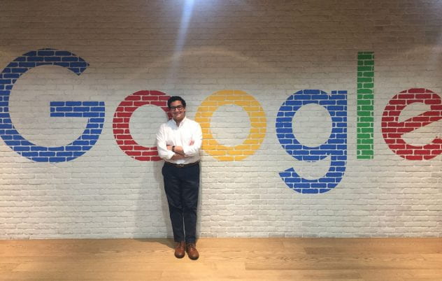Oscae Lopez poses in front of a Google mural