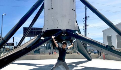 Hans Uy posing in front of a rocket at SpaceX in LA