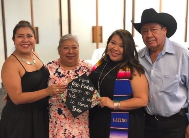 Emy with her parents at graduation. 
