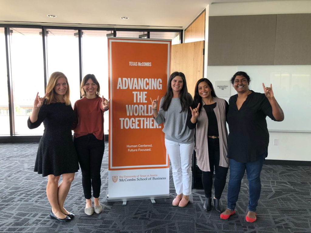 A picture of The Beyond the MBA Alumni Panel at Discover McCombs: Women's Weekend by a banner that says "advancing the world together."