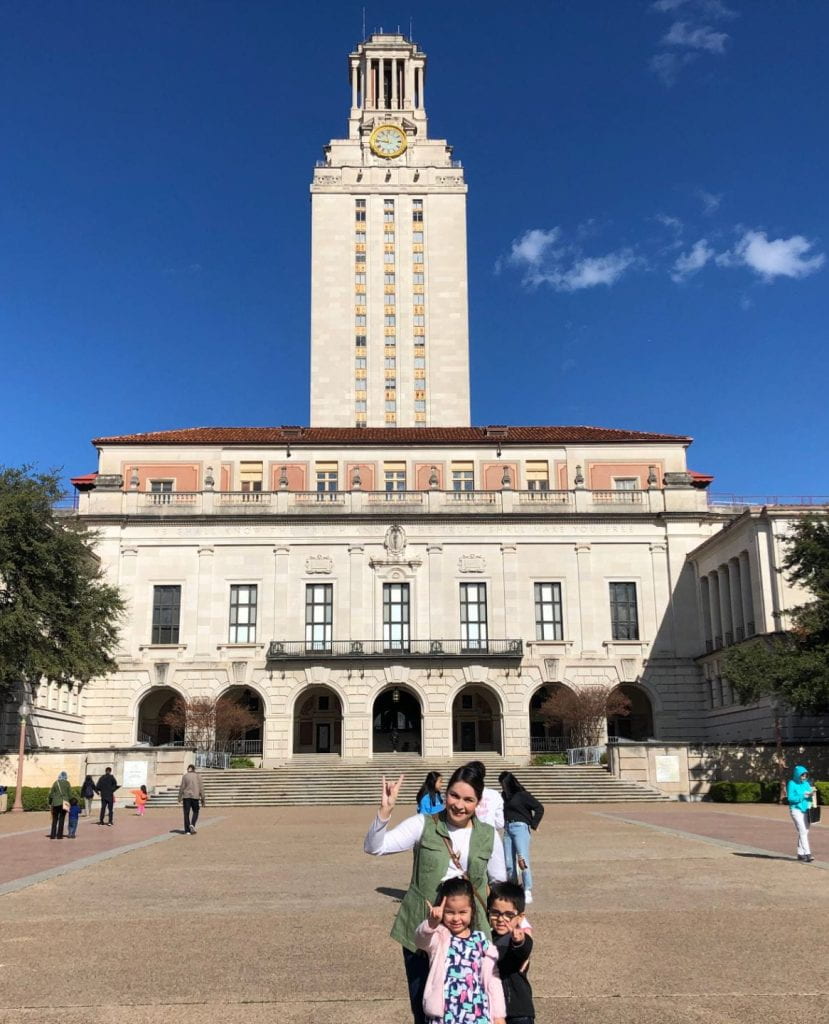 Laura and her children posing by the UT tower