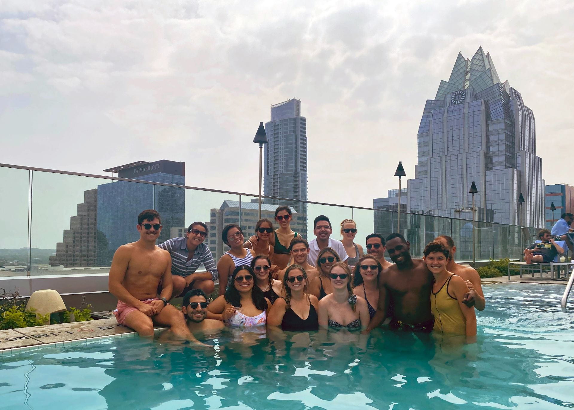 Members of eQUAL pose in a rooftop swimming pool in downtown Austin. 