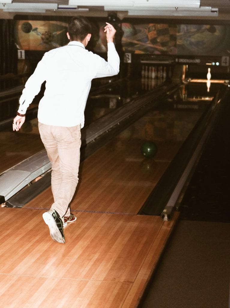 An MPA student bowls a strike at Texas Union Underground.