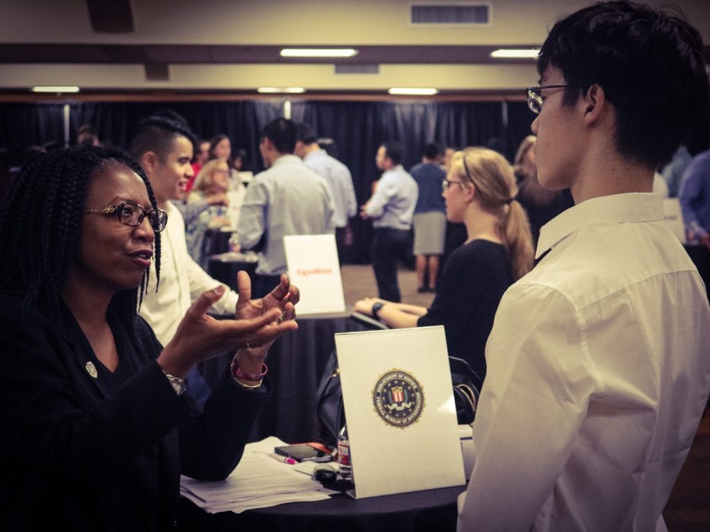 A representative from the FBI meets with a McCombs MPA student.
